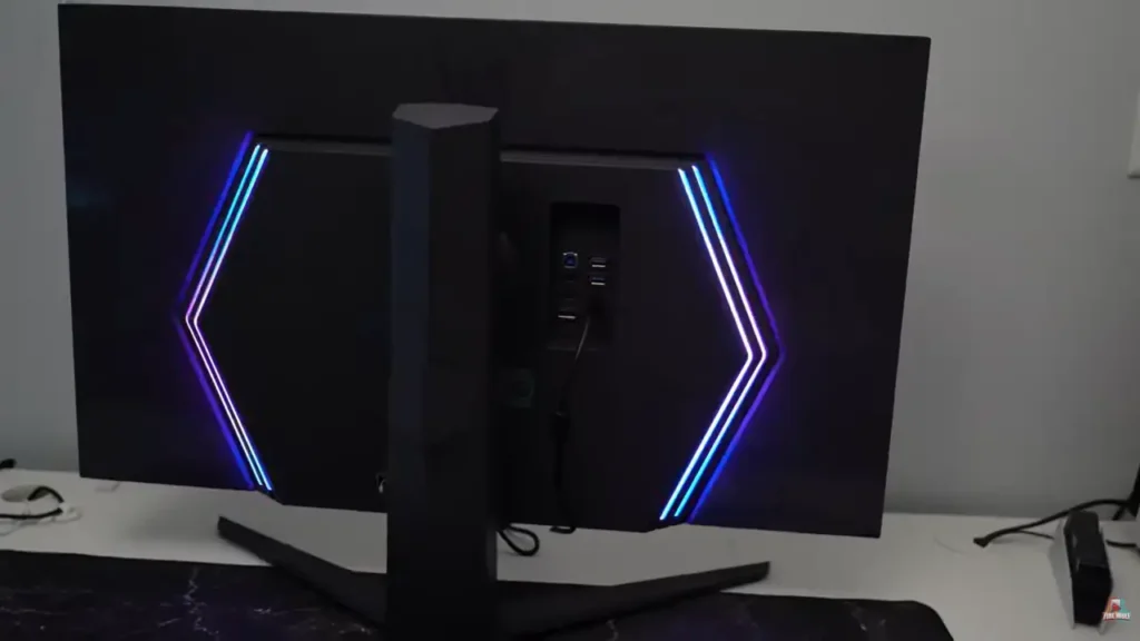 LG 32GQ950-B rear RGB lighting with hexagon design glowing in a dark setup